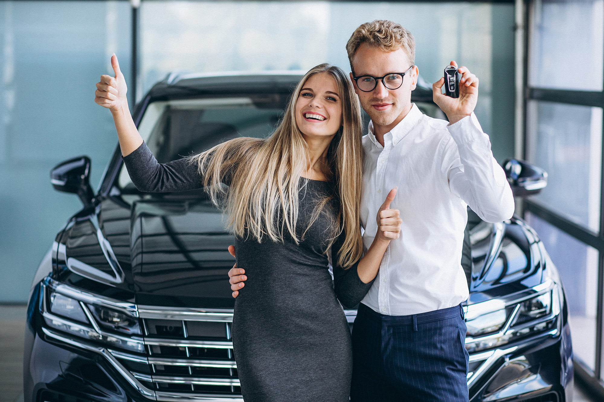 Couple choosing a car at a showroom